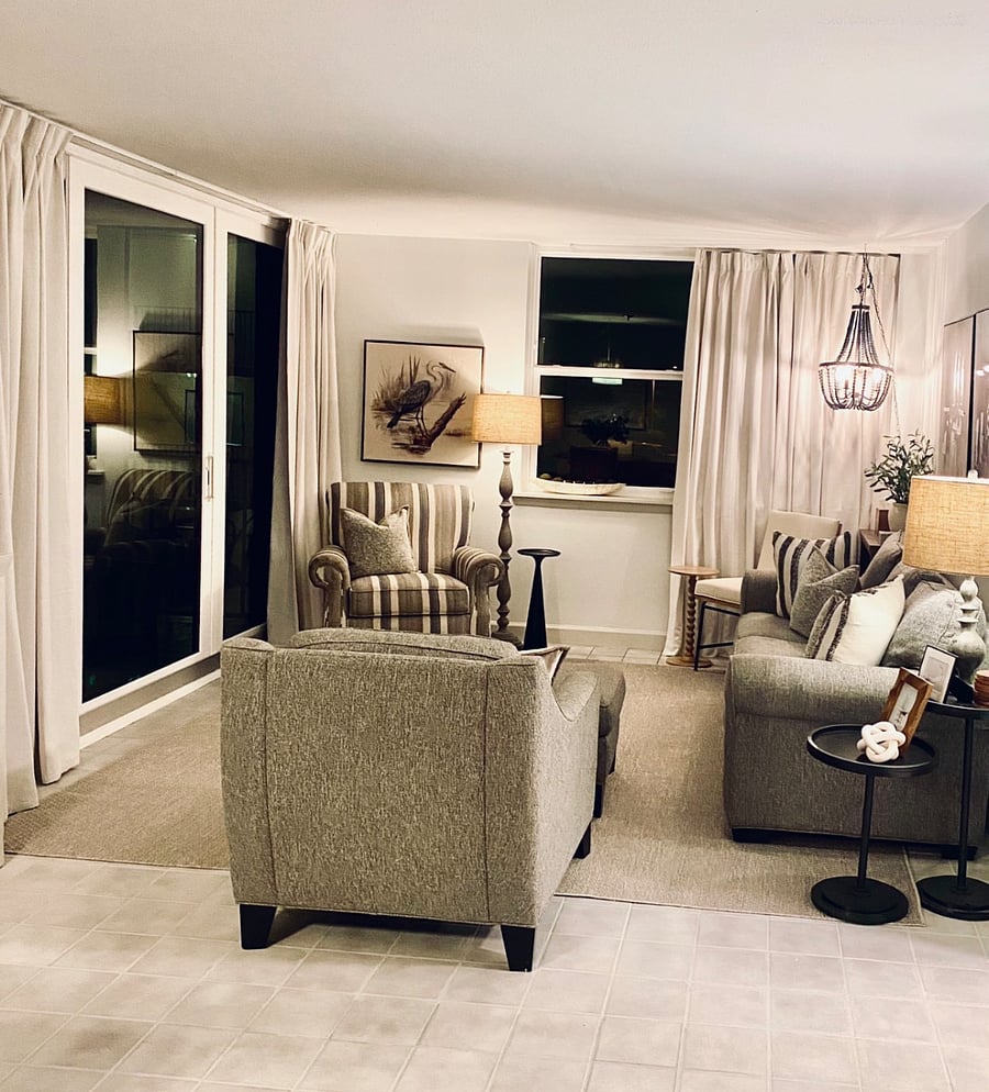 Living room with plenty of seating, sofa bed and balcony overlooking pool and beach