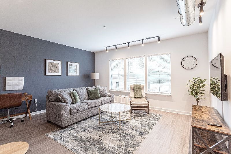 Living Room with large windows, 55" TV and Work Station with Desk.