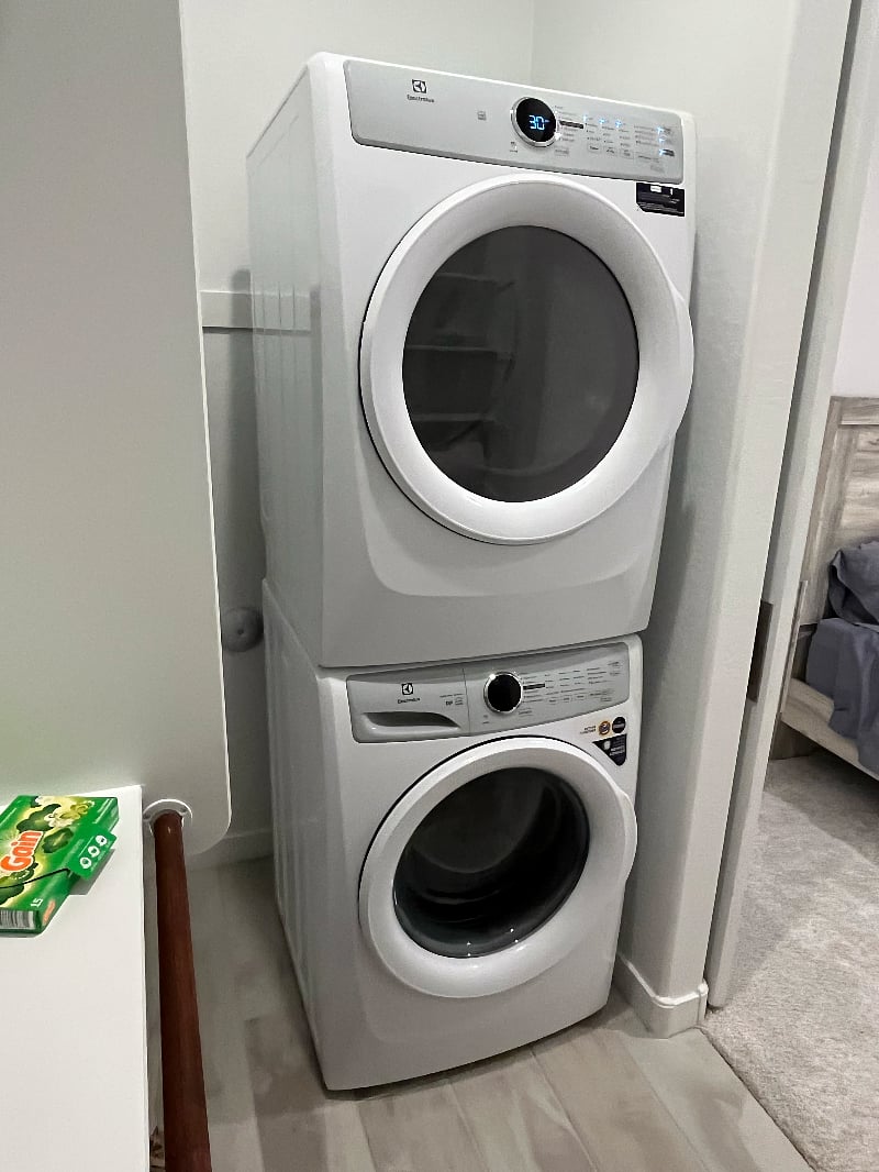 Stacked washer/dryer in bedroom closet