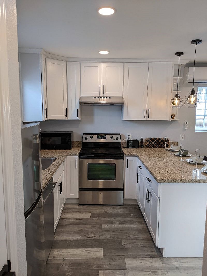Full kitchen with microwave, bread toaster, electric stove and oven, dishwasher, and full size refrigerator
