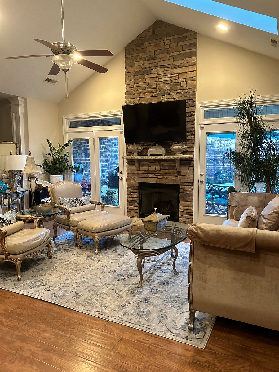 Formal living room with smart TV, gas fireplace, ceiling fan, and access to lanai