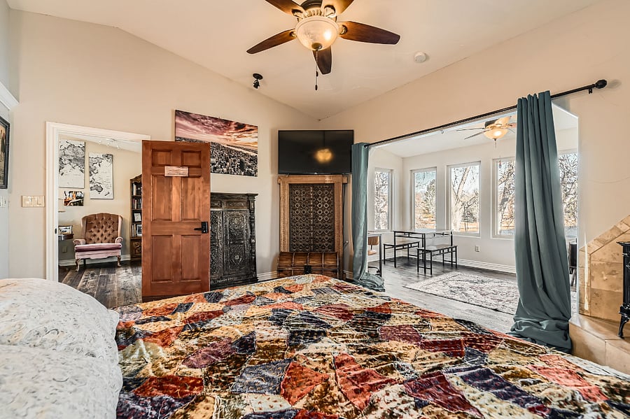 The suite's primary sleeping area is spacious and filled with natural light. The gas fireplace comes to life with a flip and there's a 55" smart tv.