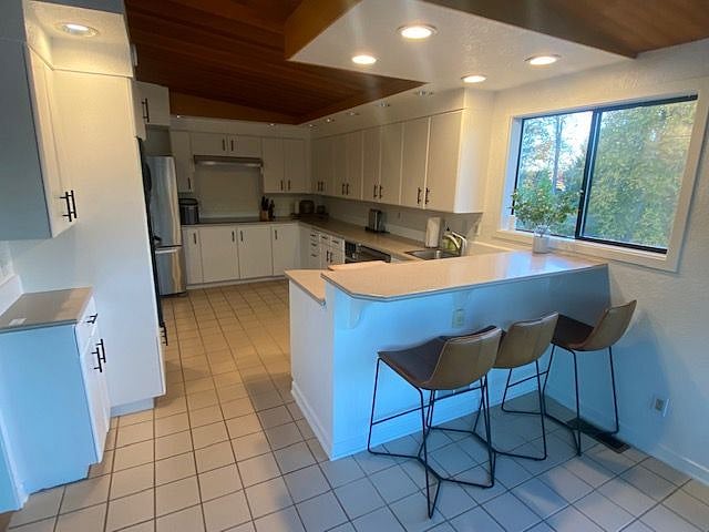 Full kitchen with frig, cooktop, microwave and dishwasher
