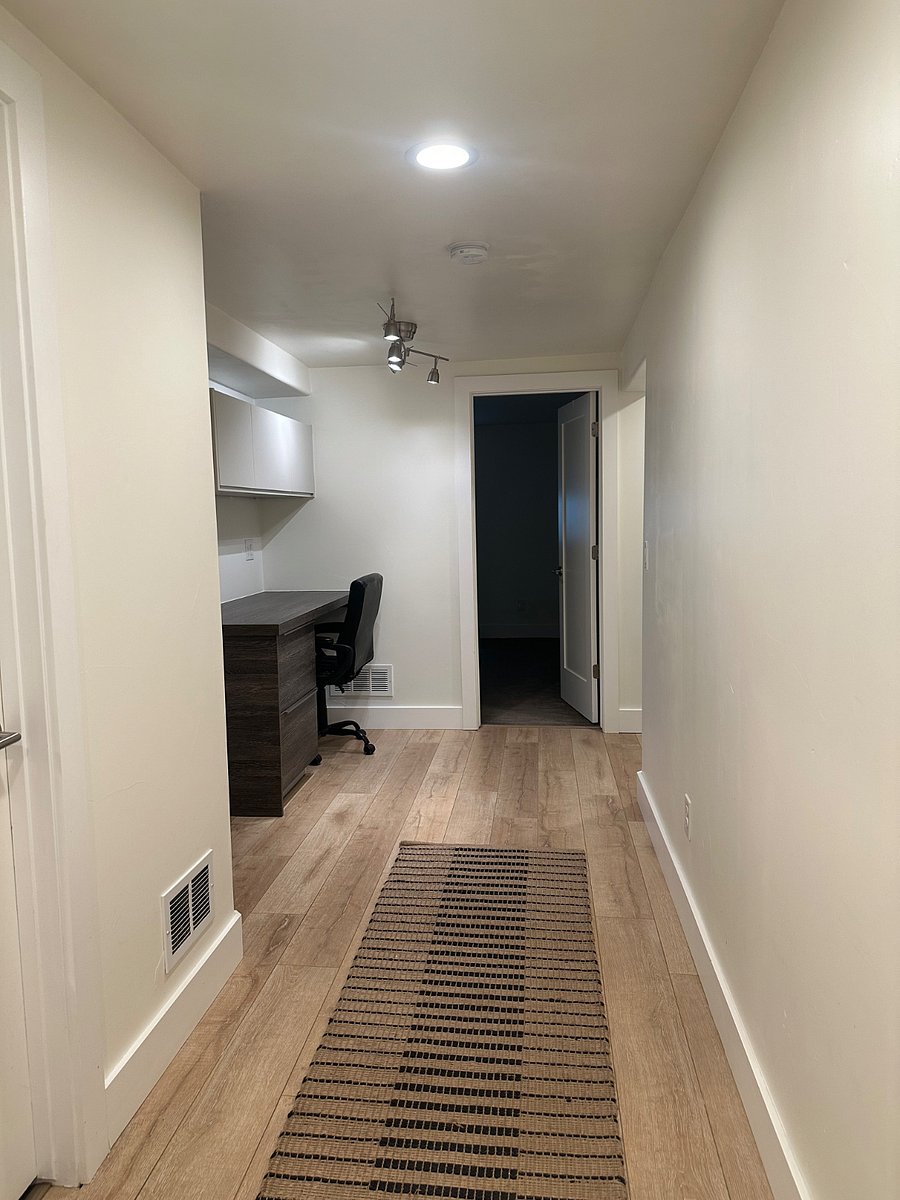 Downstairs hallway with built in office space. One bedroom is straight ahead and the other is to the right. 