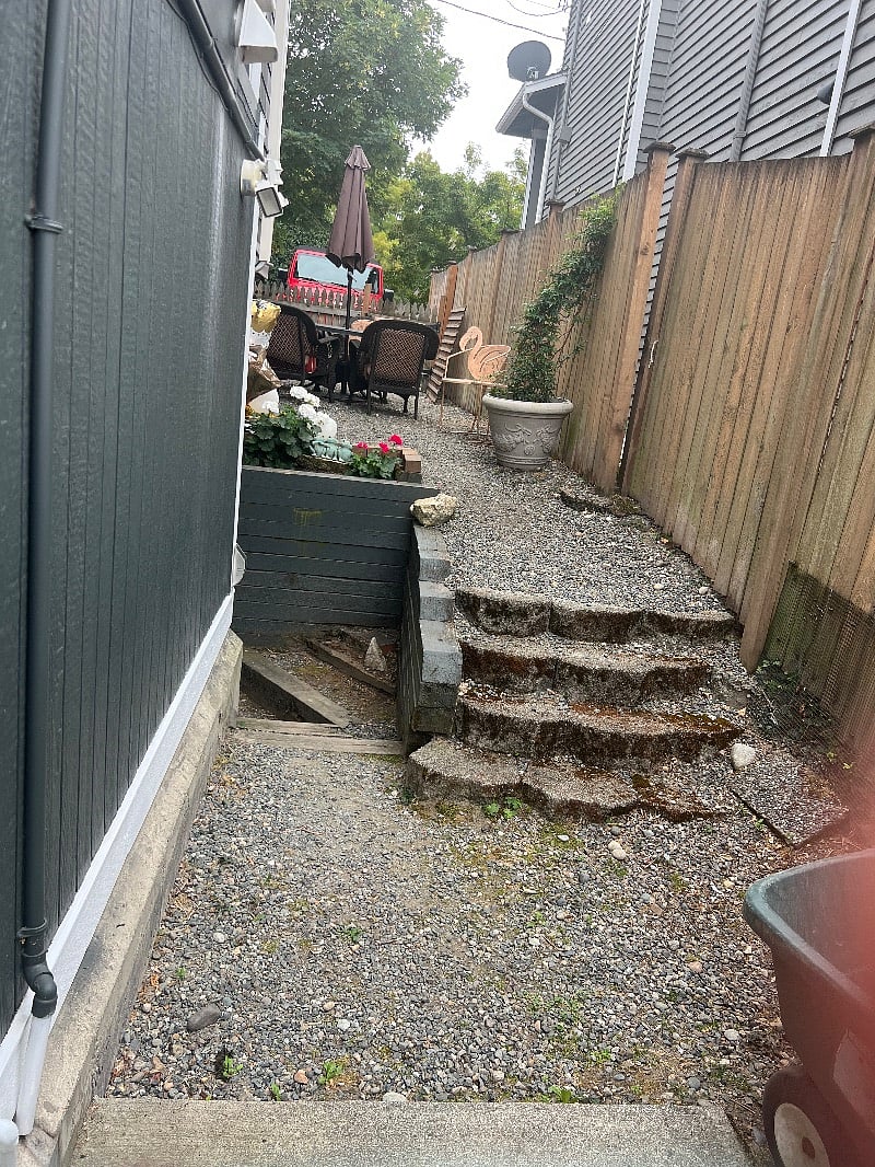 Fully fenced side yard with barbecue and outdoor seating!