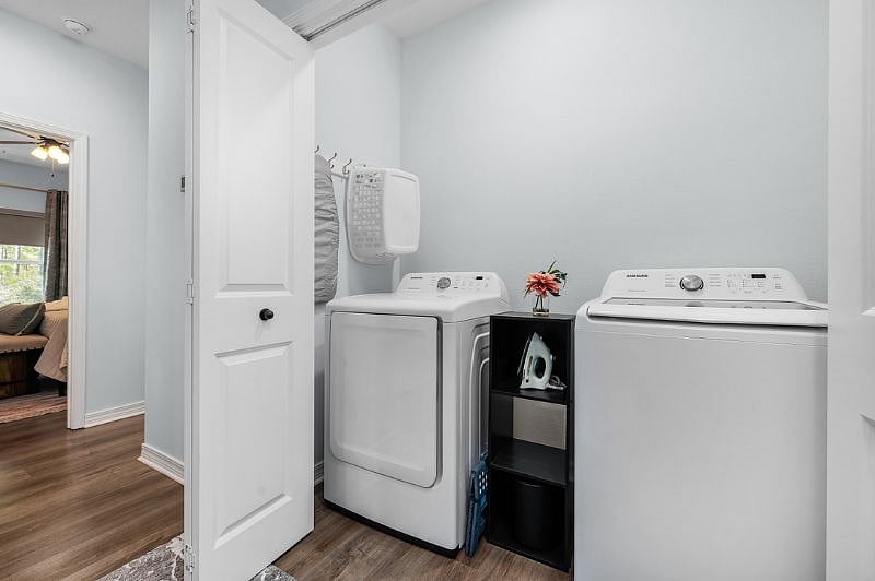 Laundry Room with Iron and small Ironing Board. Shelf for cleaning items