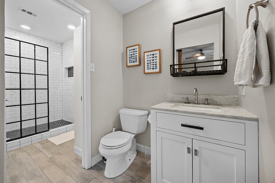 Primary bath: Jack-and-Jill-style bathroom with a shared shower and separate restrooms.