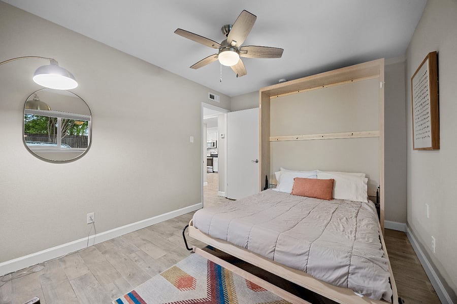 Secondary bedroom: A queen-sized Murphy bed allows for a seamless switch between the office and bedroom!
Top-down, bottom-up shades (blackout in bedrooms) maximize privacy and natural light.