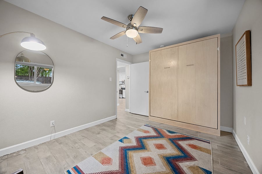Secondary bedroom: A queen-sized Murphy bed allows for a seamless switch between the office and bedroom!
Top-down, bottom-up shades (blackout in bedrooms) maximize privacy and natural light.