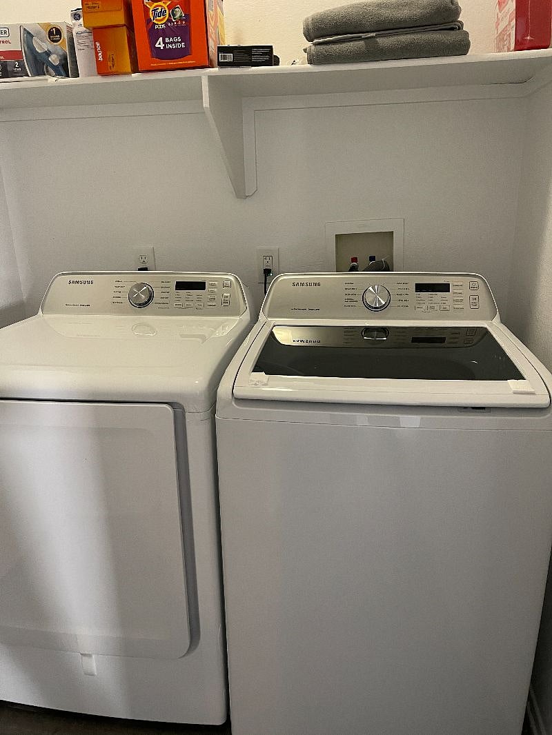 Laundry room with New  Samsung washer and drier. Also available is a  table top ironing board and iron.. 
