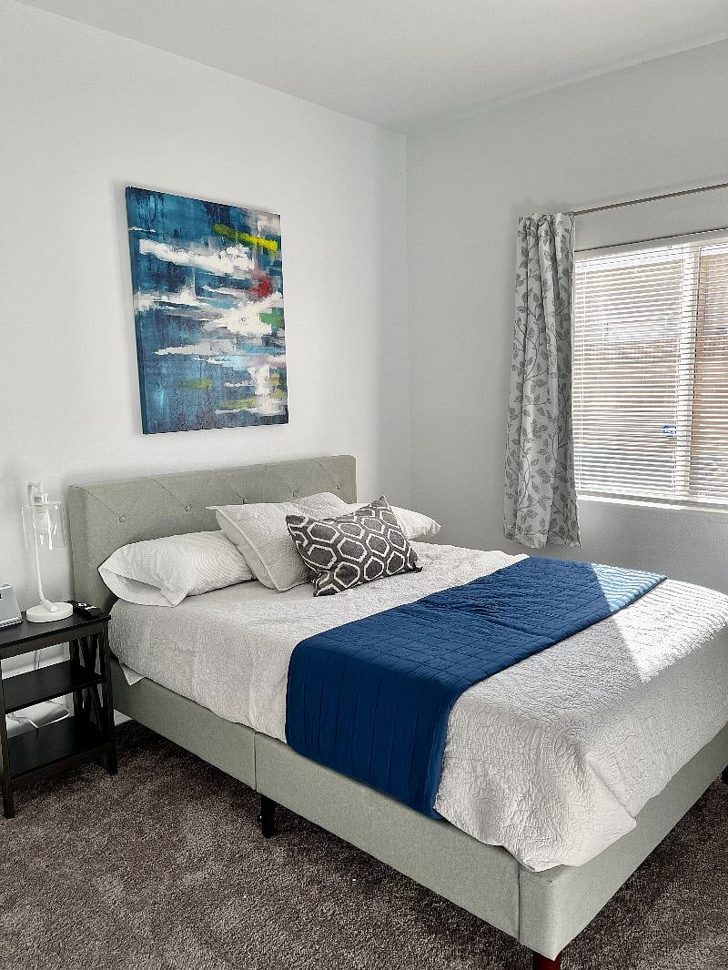 Comfy Linus 12 inch mattress on full bed. If you like light and bright rooms this is the one. Black out blinds can darken it up for sleeping. Charger and white noise machine on night stand.