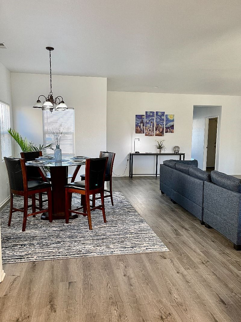 Dining area overlooks the large sectional  sofa and 65 inch TV.