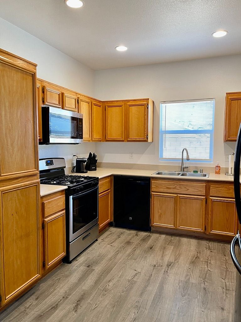 Newer microwave and stove. Large pantry on the left.