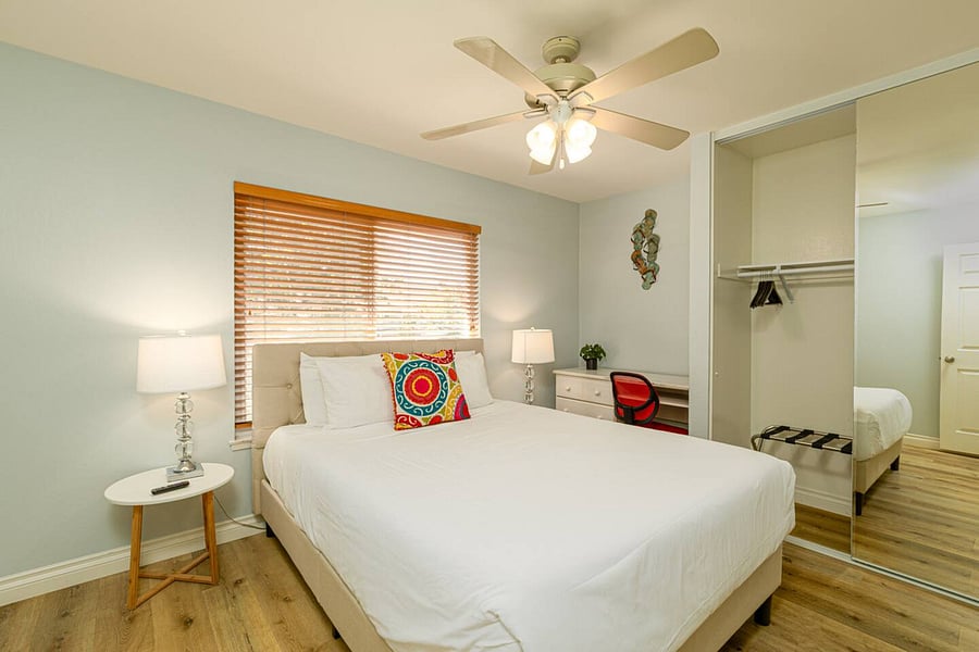 There are computer desks in the living and bedroom areas