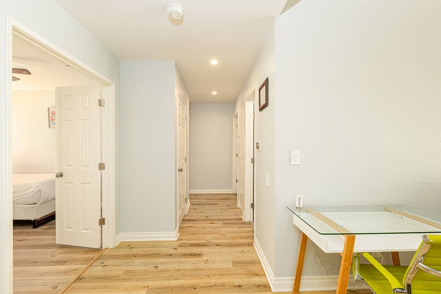 There are computer desks in the living and bedroom areas