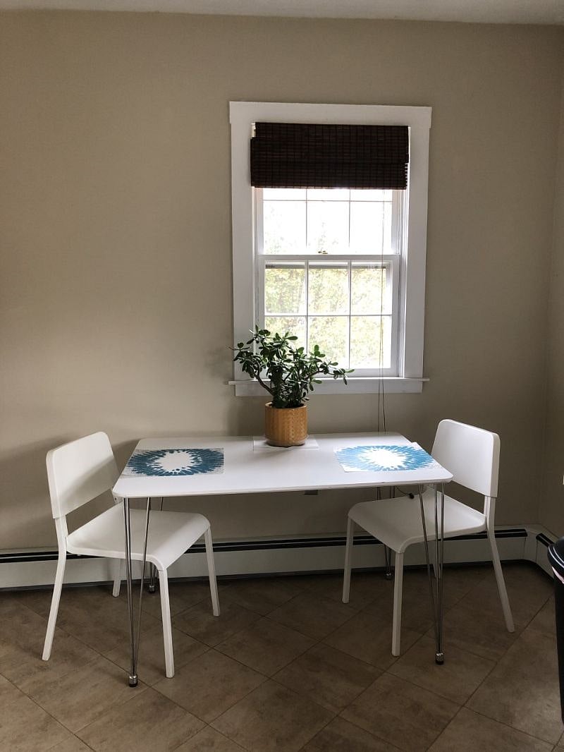 Kitchen table by rear window view.