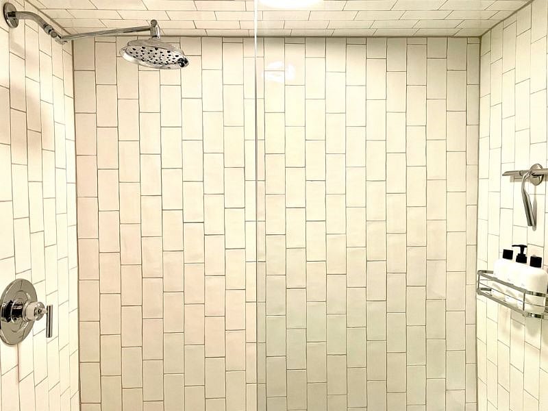 Ivory Moroccan subway tile lines the beautifully updated showers.