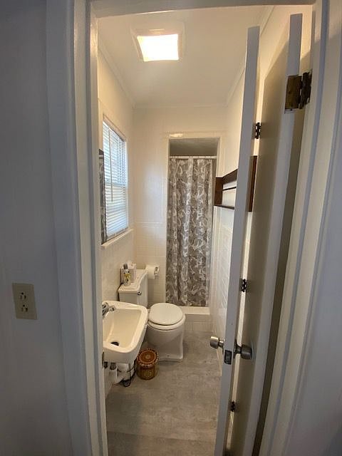 The bathroom is tiny as well BUT it does come with it's own vanity, commode & tiled shower!