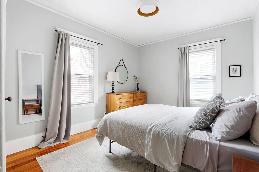 Main bedroom with queen bed, dresser, and closet