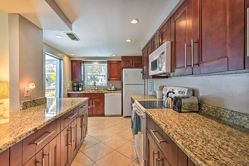 The oversize kitchen comes fully stocked and gives access to the lanai.