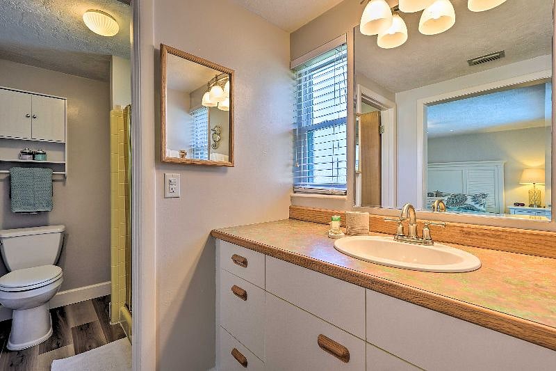 Master Bath sink area has plenty of storage and comes equipped with hair dryer.