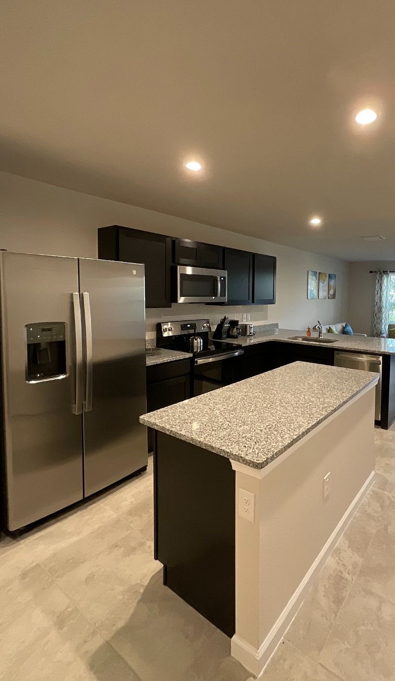 Modern kitchen with top of the line appliance and espresso cabinets. Includes all pots and pans, dishes, cups, drinking glasses and cooking and dining utensils, bakeware, coffee maker, toaster, etc.