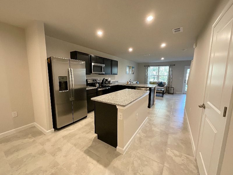 Modern kitchen with top of the line appliance and espresso cabinets. Includes all pots and pans, dishes, cups, drinking glasses and cooking and dining utensils, bakeware, coffee maker, toaster, etc.