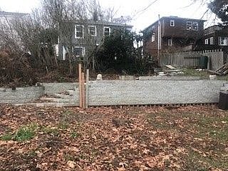 Off street parking with a new retaining wall and steps up to the house.