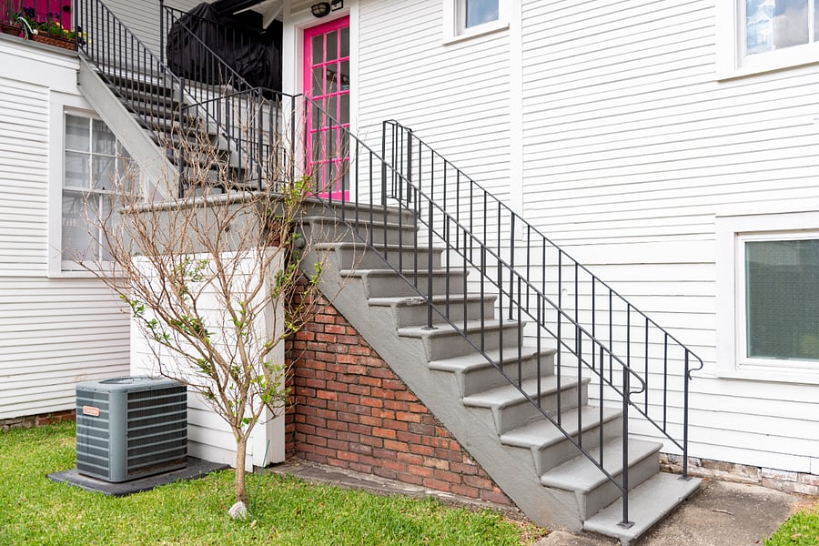 Ascend a small staircase to reach the entry, the first pink door to the right.