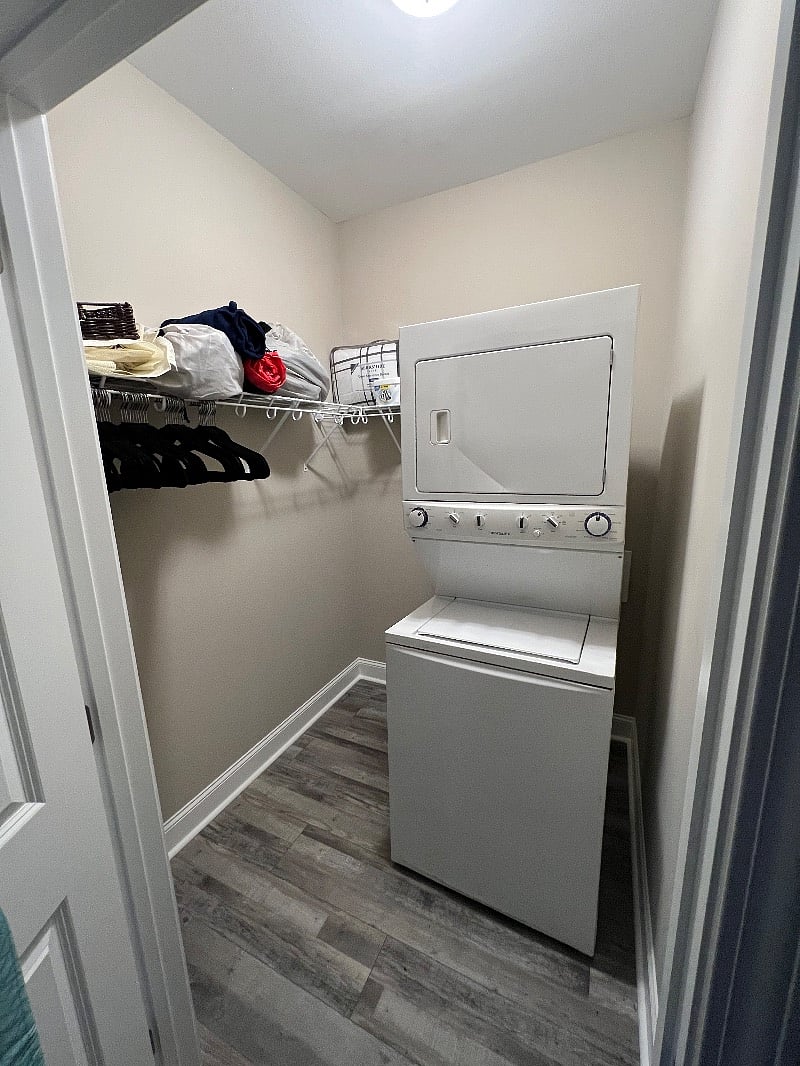 New GE stackable washer/dryer with laundry detergent and softener supplies