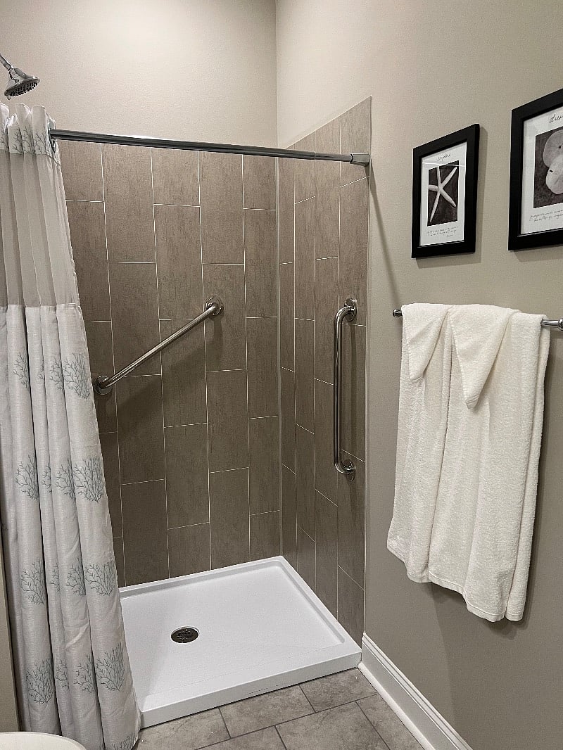Low threshold shower with grab bars