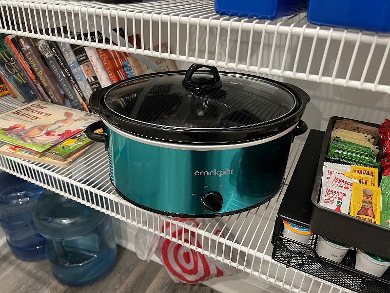 Expansive well stocked pantry with crock pot, blender, air fryer, waffle maker books and games.