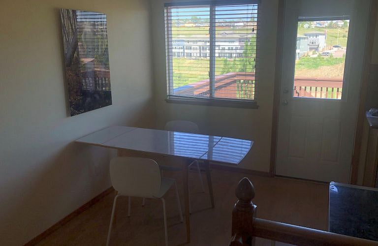 Dining table with view of your deck. The new homes being built in this picture are your closest neighbors behind the house.