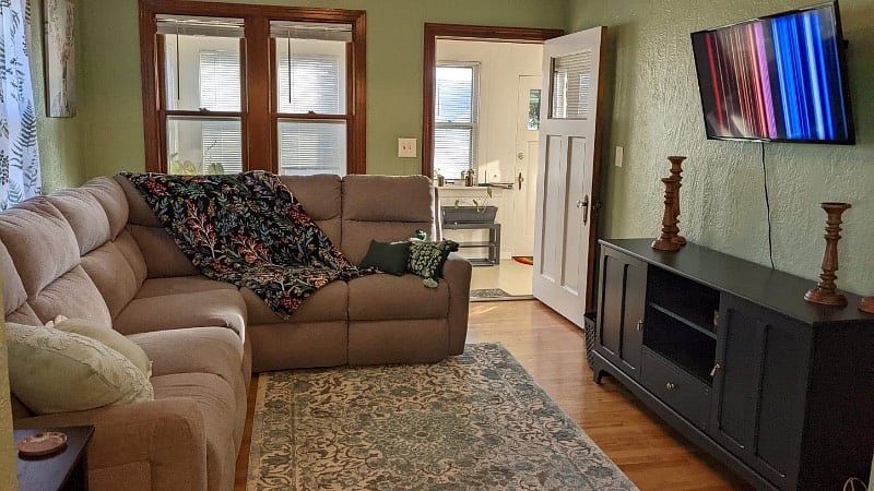 Living room with 40 inch smart TV (enclosed heated/cooled porch is visible beyond)