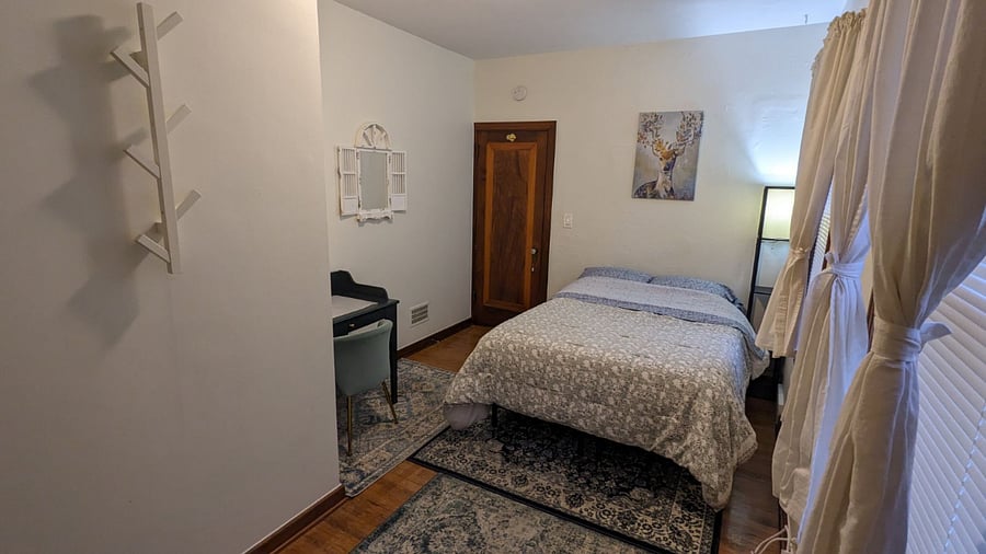 Private bedroom with Full bed, desk, and double closet.