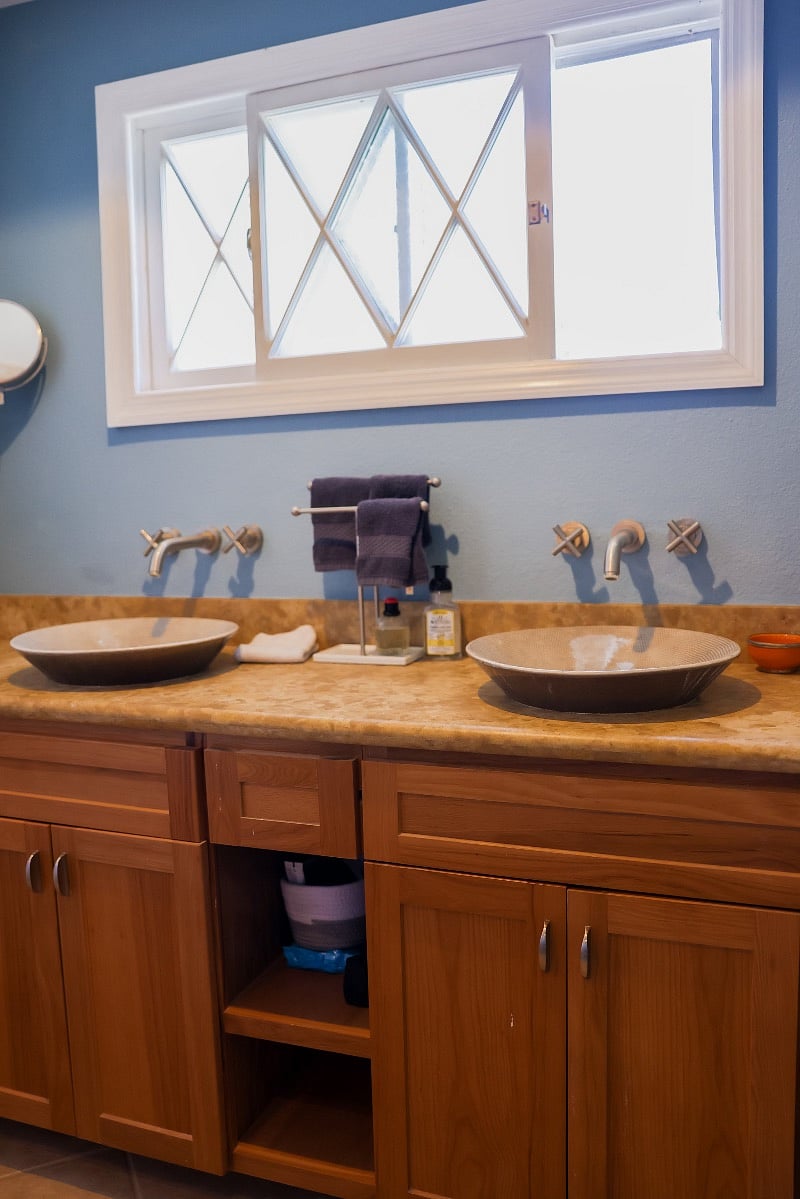 Two sinks and large walk-in shower with seat