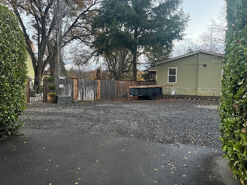 Behind large laurel hedges--that provide a sense of privacy for Le Jardin Familial--we have a large graveled parking area for all of our guests and tenants and the property it fenced and gated, with an security system and security cameras for additional protection.