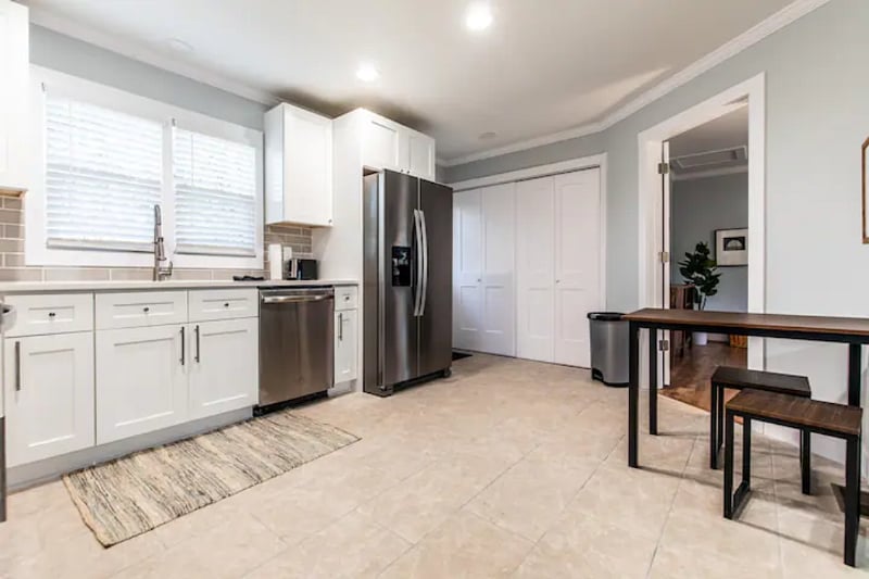 Kitchen has eat in table and stools for extra space