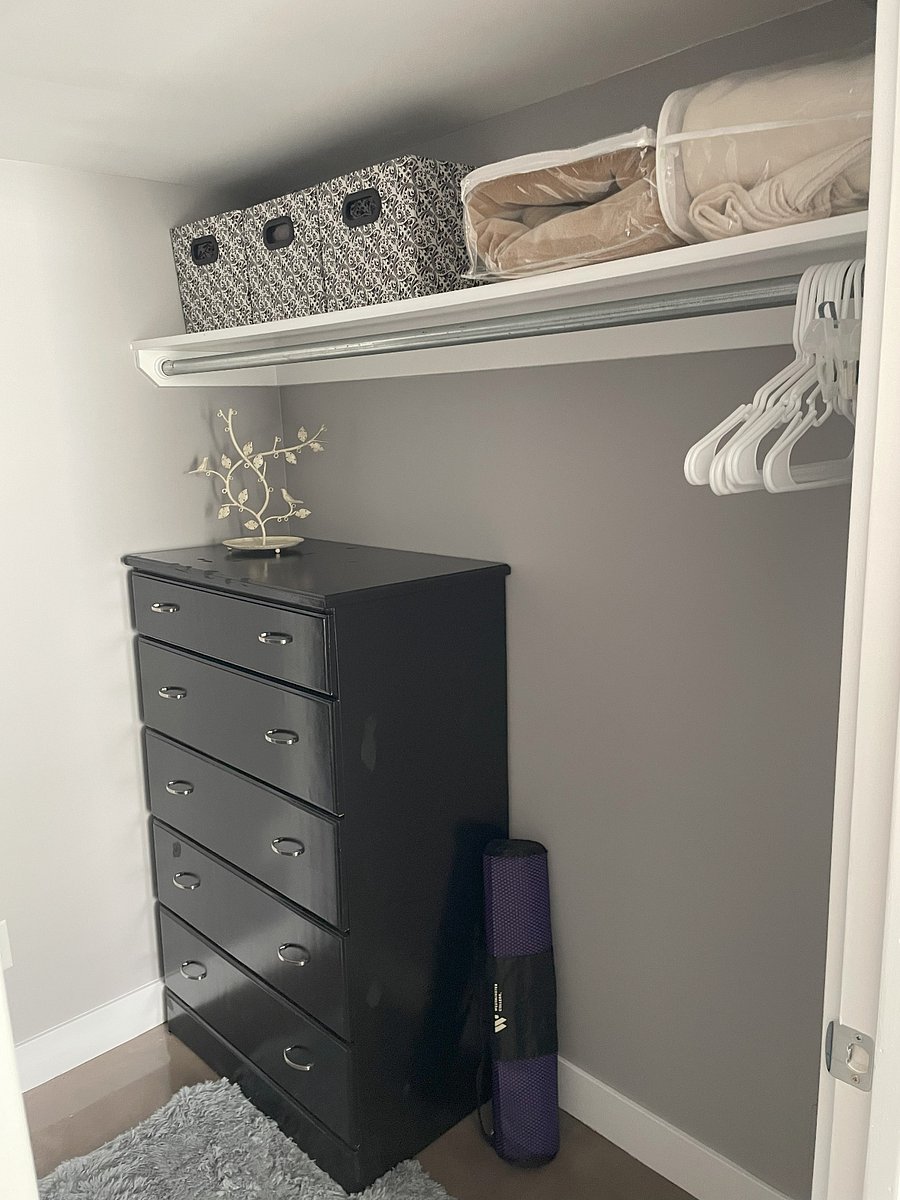 Walk through closet has ample room for hanging and includes dresser