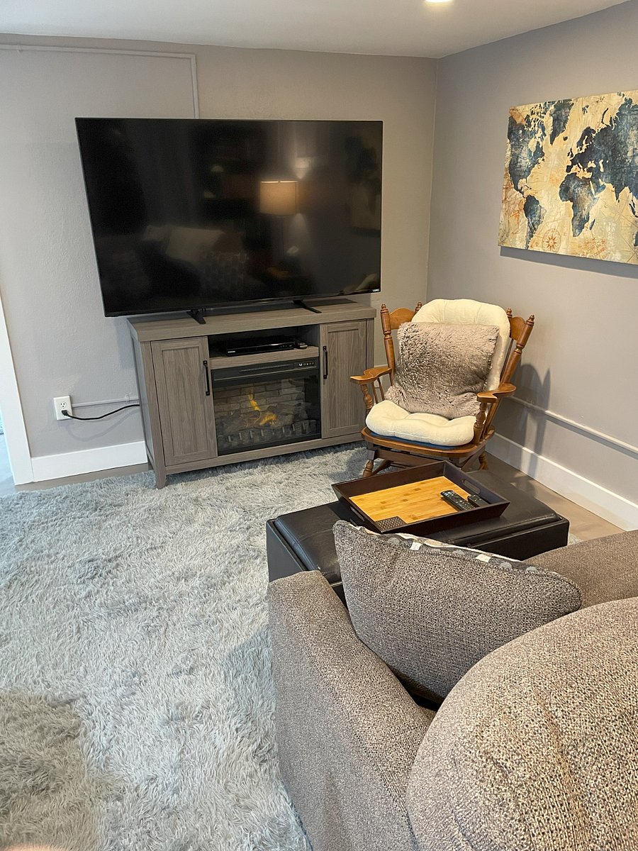 Living room has electric fireplace for ambience and extra heating