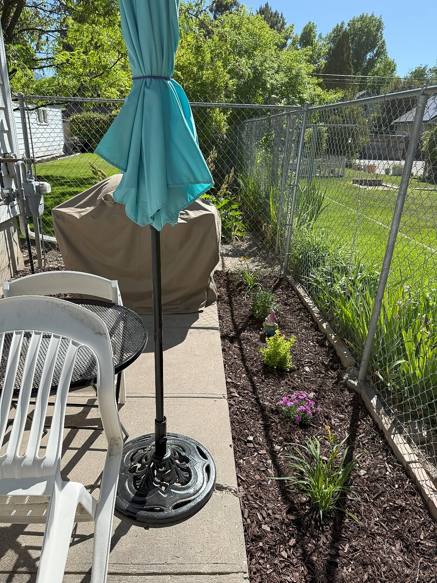 Patio includes table, chairs, umbrella, and BBQ grill for use