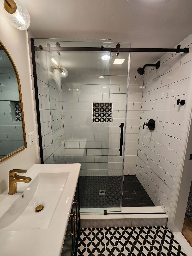 Walk-in shower w niche for products.