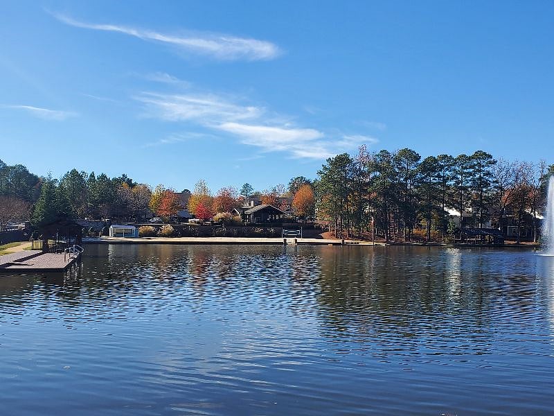Community lake/walking path looking back at townhouse community