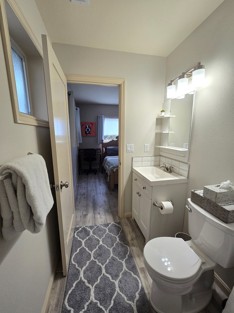 Each bedroom includes a private bathroom (with new sink vanities, toilets, and showers), 58" flat screen Smart TV, and a desk and office chair.