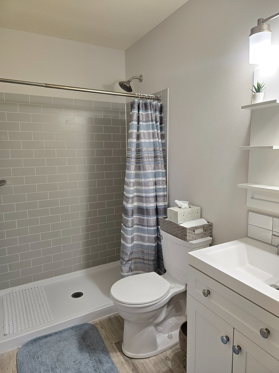Each bedroom includes a private bathroom (with new sink vanities, toilets, and showers), 58" flat screen Smart TV, and a desk and office chair.