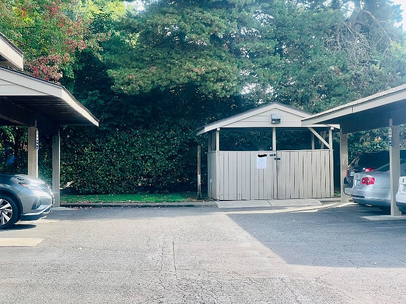 Garbage and Recycling containers are available in the structure at the end of the carport next to the condo.
