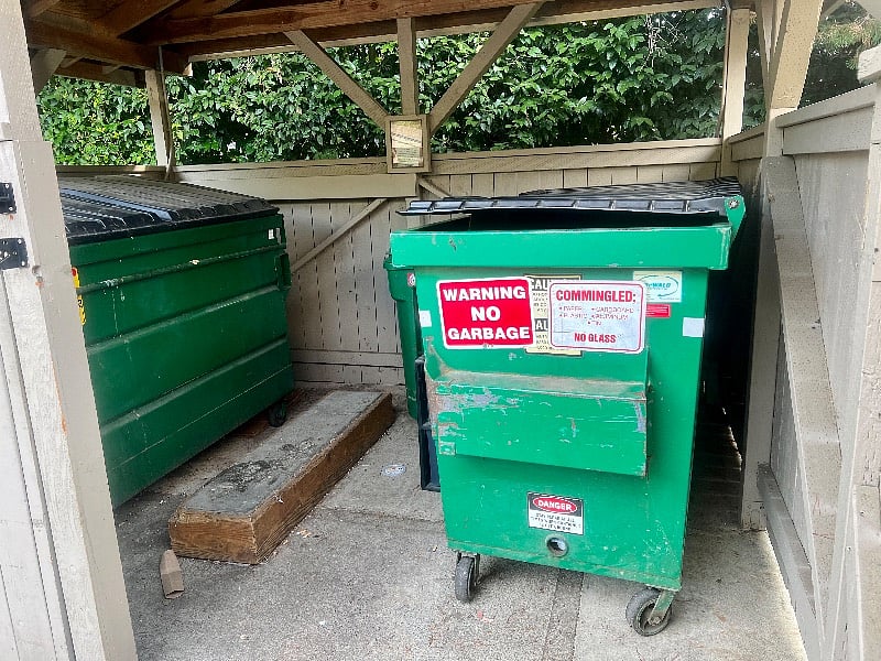 Garbage and Recycling containers are available in the structure at the end of the carport next to the condo.