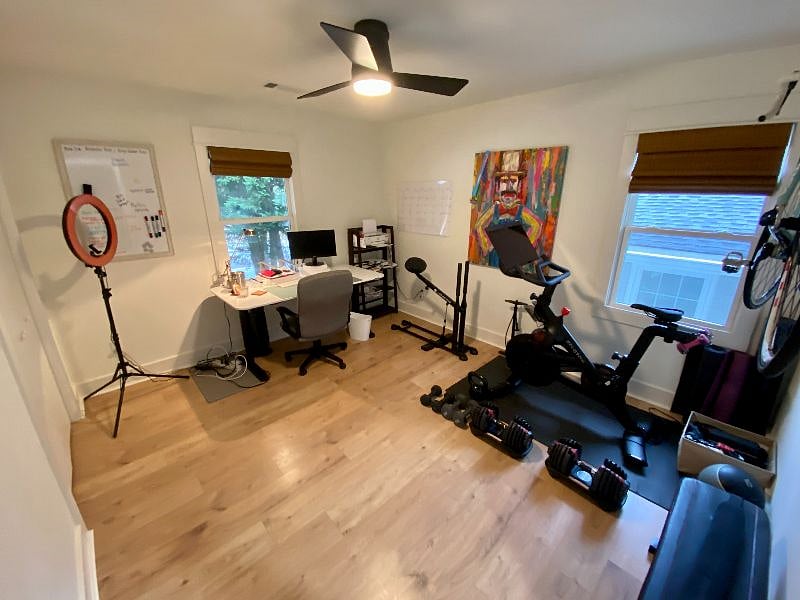 Office / gym with a Peloton, Bowflex adjustable weights, a bench, mats and bands. There's room for another desk in here.