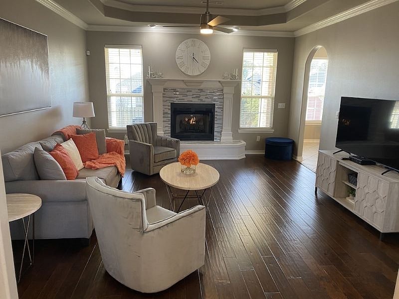 Spacious living room with full couch and two individual cushion seats, gas burning fireplace and 65" LED/Smart TV, remote operated ceiling fan great space to unwind from a busy workday.