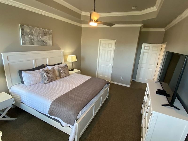 Master bedroom offers a spacious King size bed, two nightstands and lamps, 65" LED/Smart TV, remote operated ceiling fan